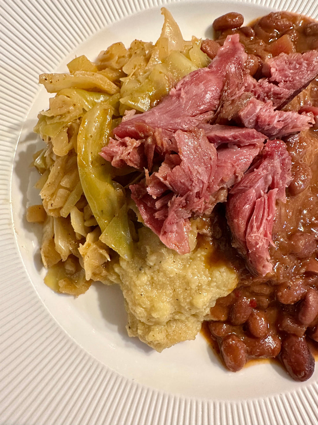 Masala Braised Green Cabbage with Polenta, Pinto Beans, and Ham