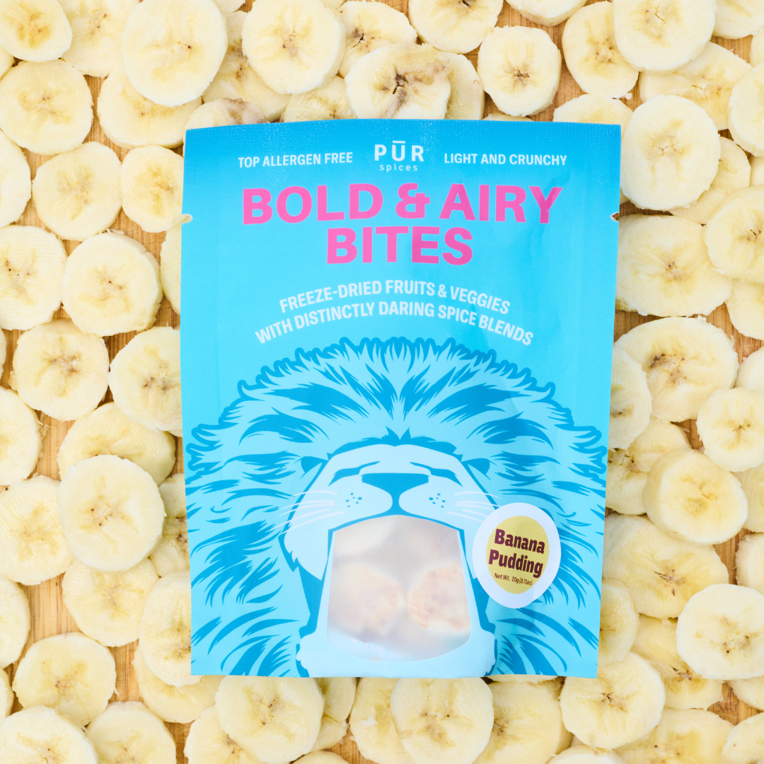 Packaging of 'Bold & Airy Bites' on a bed of sliced bananas